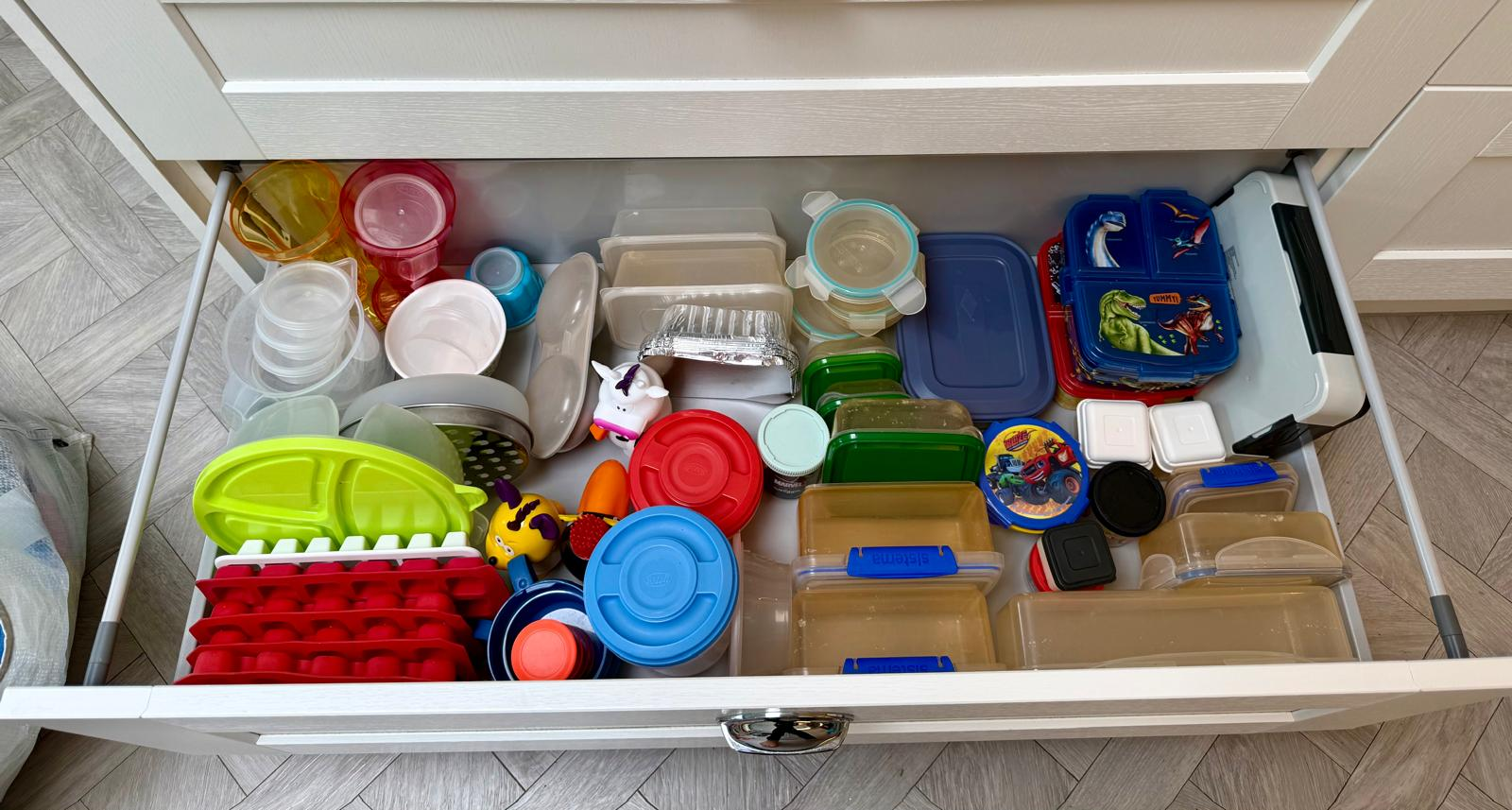 Food container drawer after organising, with tubs nested and lids grouped by size