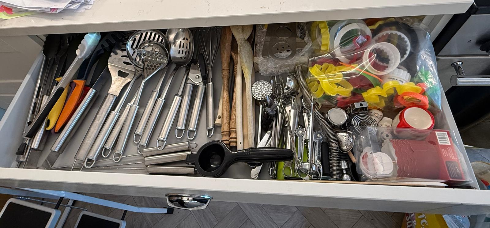 Utensil drawer after organising, with tools grouped and lined up in sections