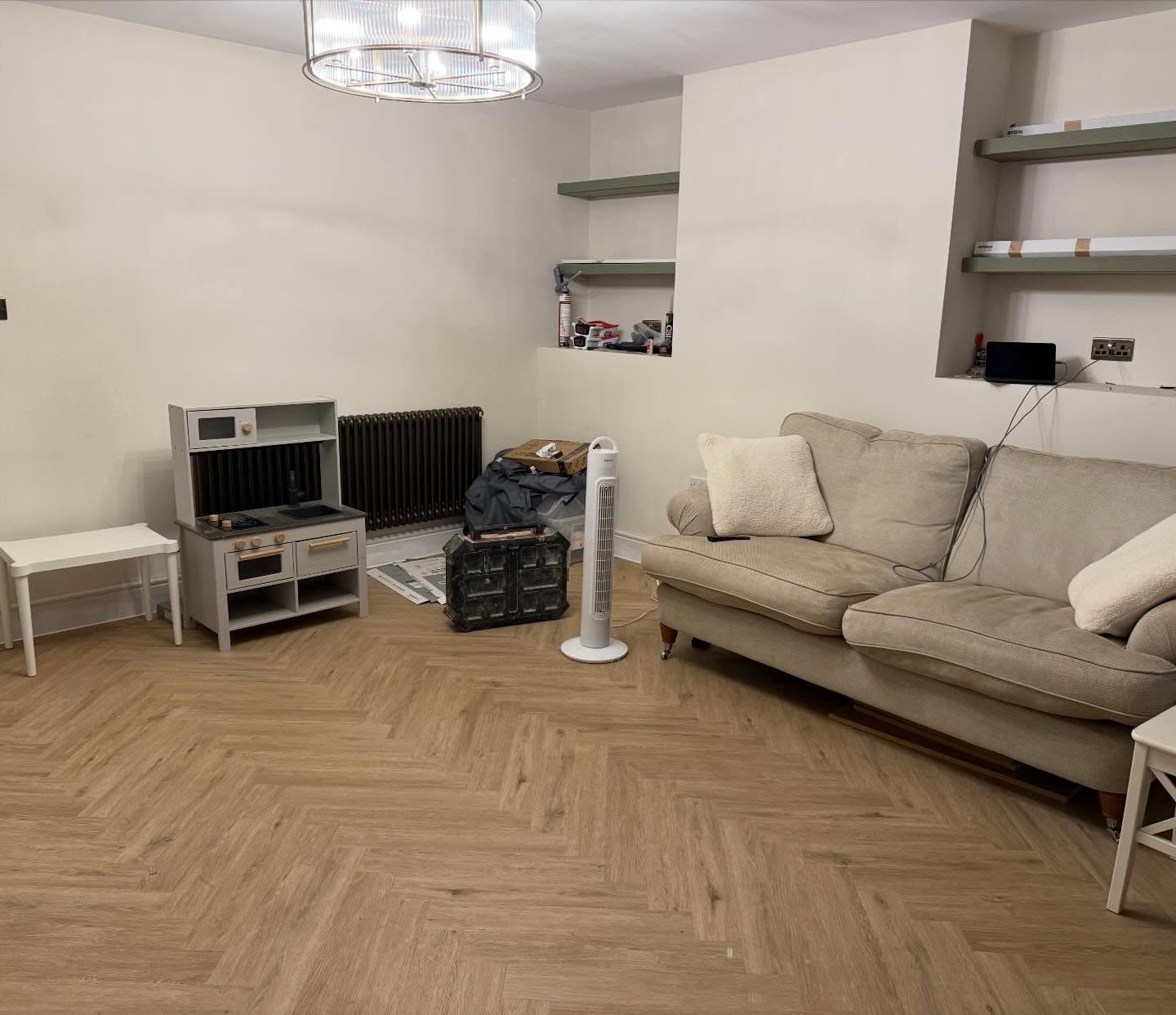 Living room after organising, with clear floor space and tidy shelving