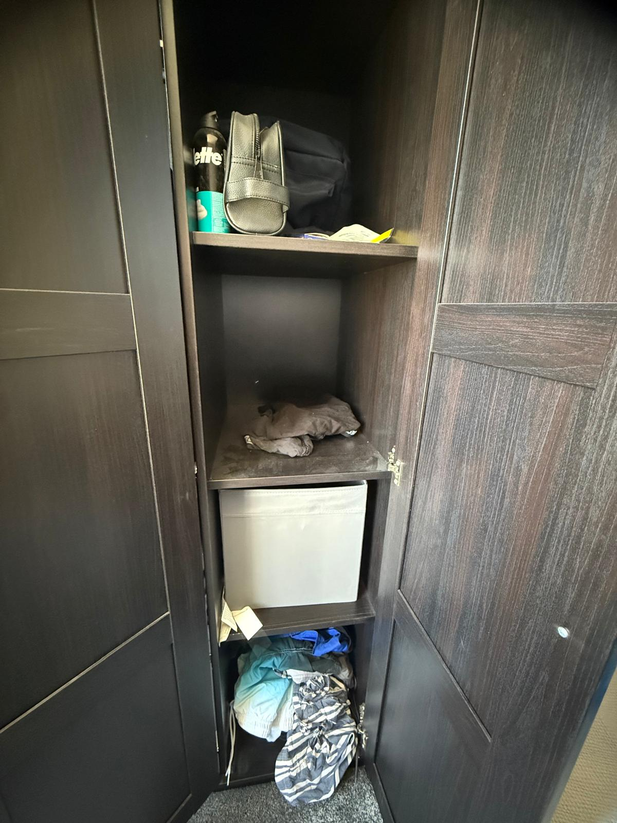 Wardrobe shelves before organising, with loose clothing and empty gaps