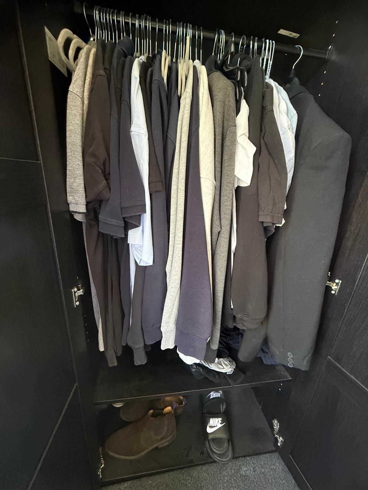 Wardrobe rail before organising, with tops crowded on mismatched hangers